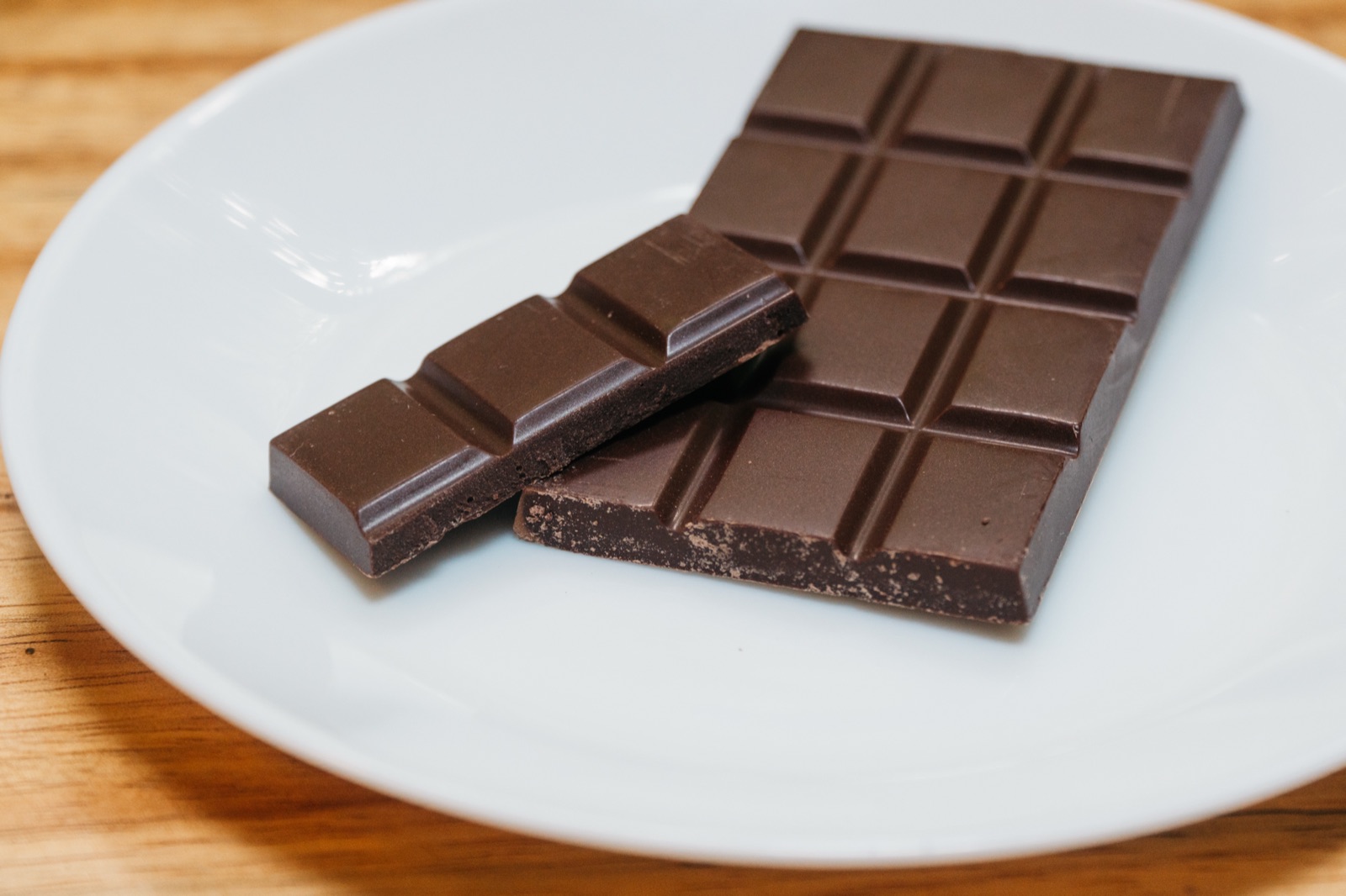 A Halimao bar at room temperature on a white plate, a couple of tiles snapped off